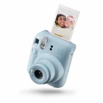 Instax Mini camera with a developing photo.