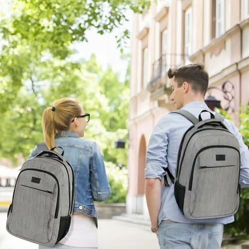 Two people walking with gray backpacks